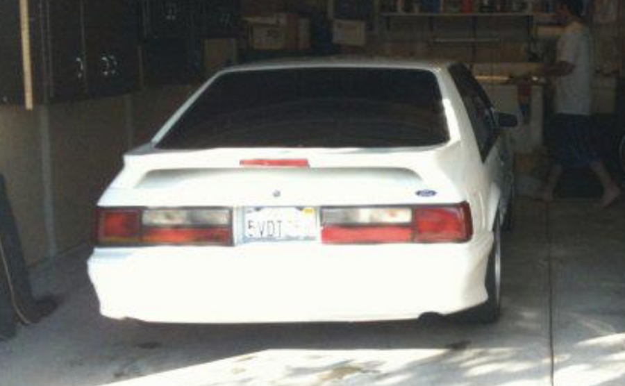 Greg's white Fox Body Ford Mustang — California plates 5VDT — in the garage